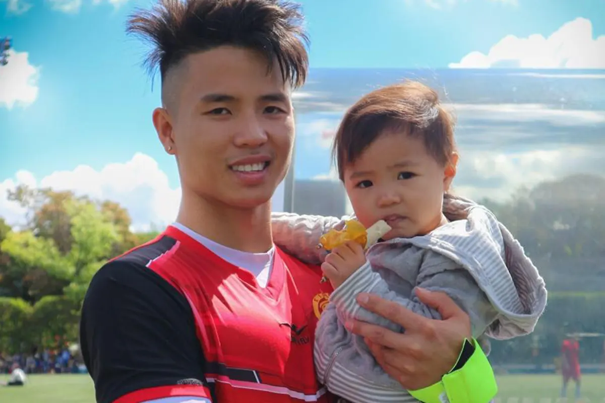 About Nam Dinh, owner of Ace Bath, holding his child