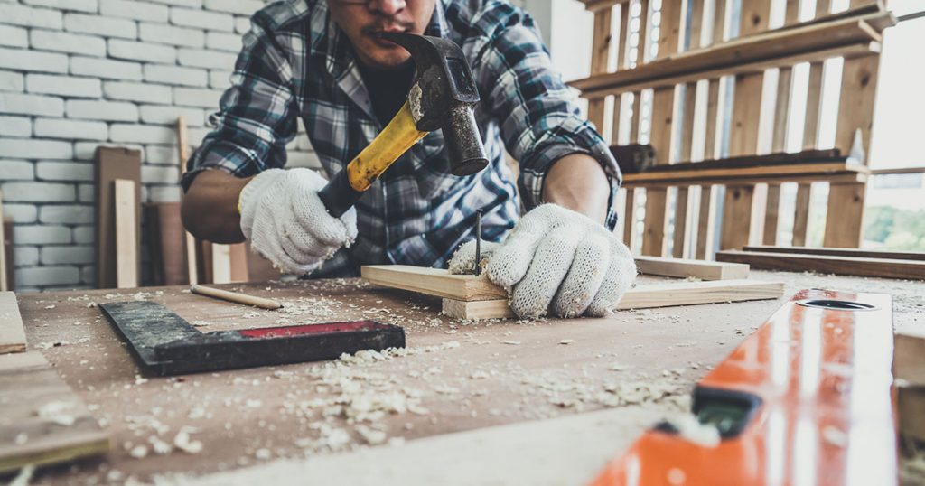 A bathroom renovator working with wood