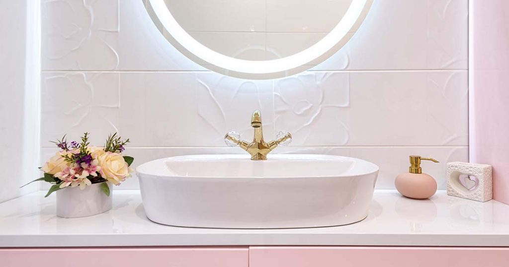 pink vanity and lighted mirror