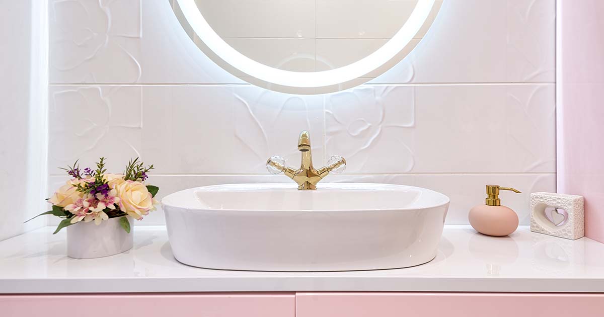 pink vanity and lighted mirror