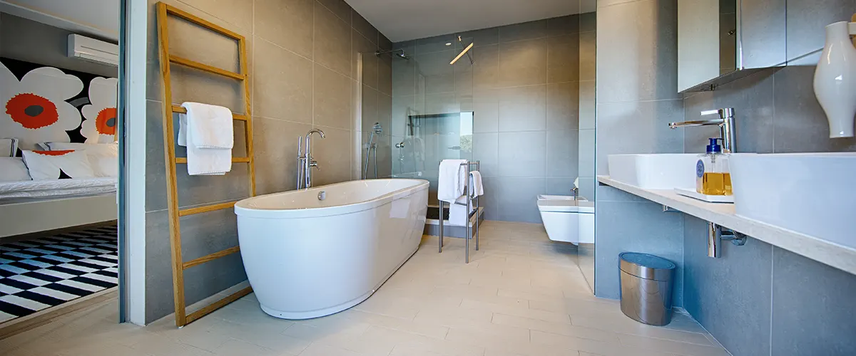 A modern bathroom with big gray tiles on walls