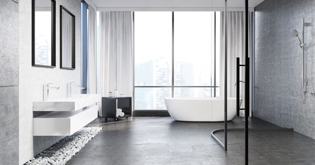 A modern bathroom renovation in Toronto with gray tiles and decorative stones under sink