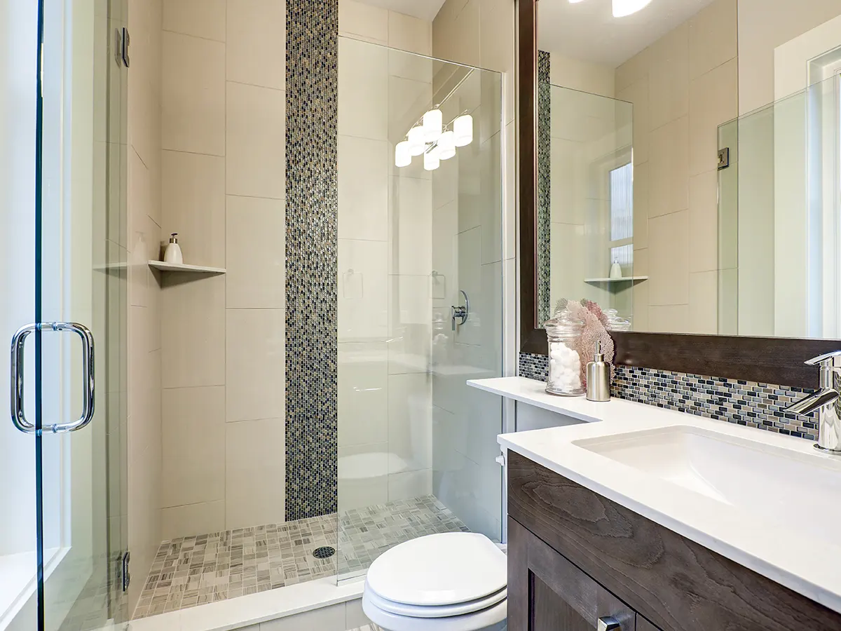 A bath renovation in Vaughan with a brown vanity and glass shower