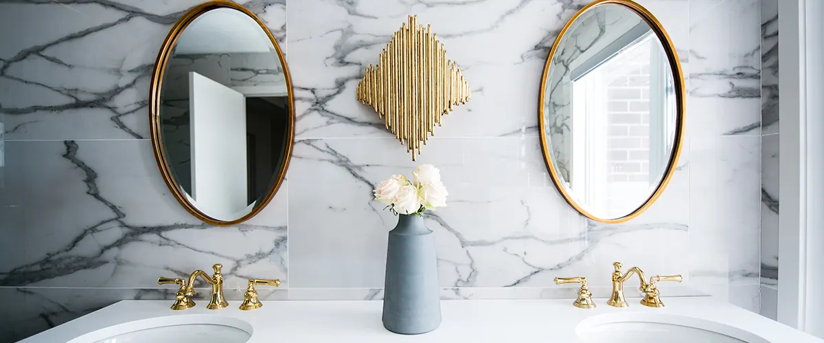 two golden mirrors and marble tile