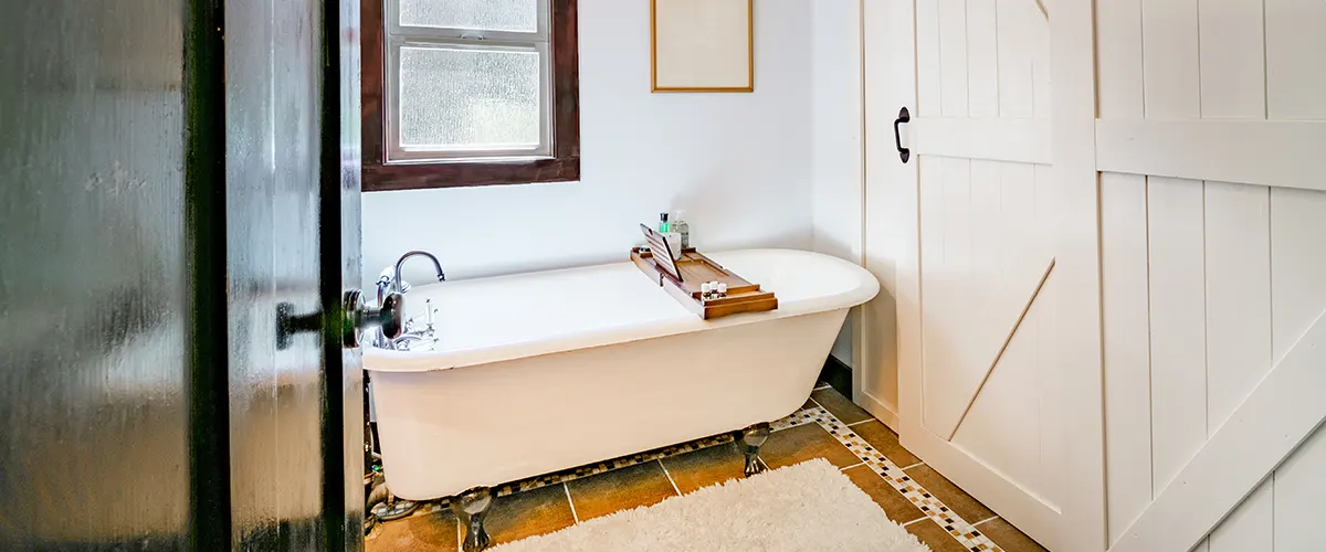 wooden barn doors and freestanding tub