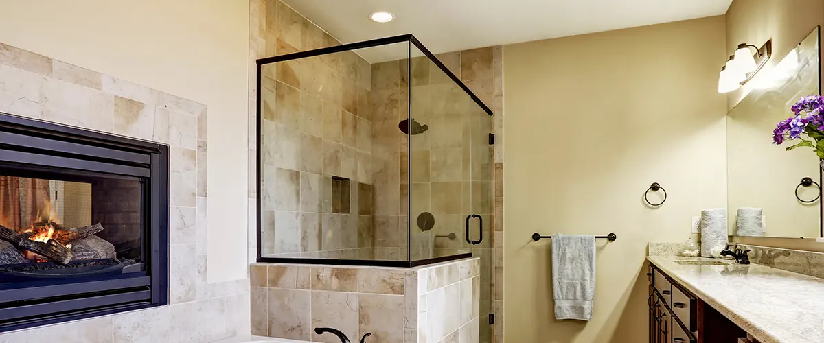 brown tile bathroom with fireplace