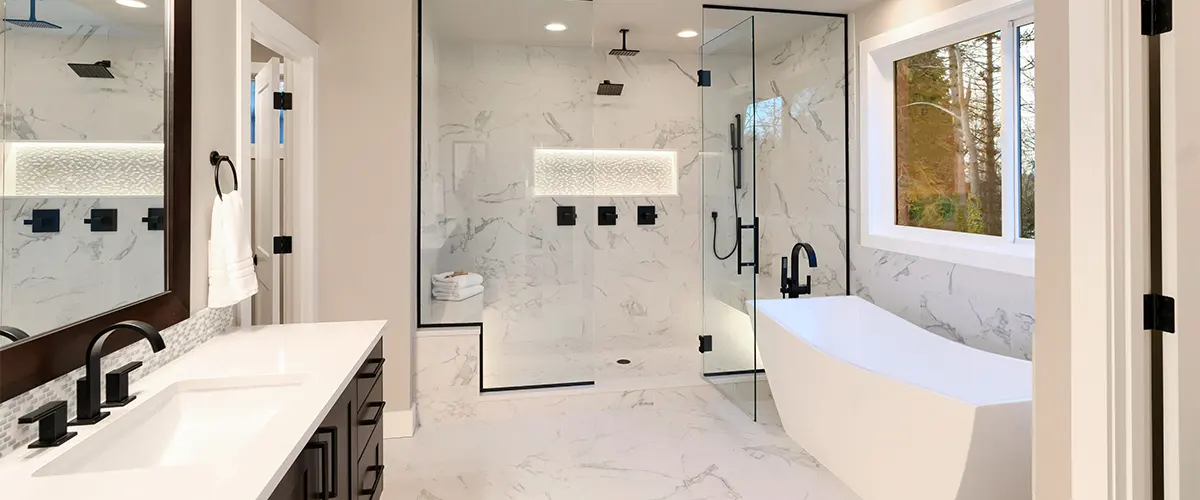 A white bathroom with bathtub, shower, and sink with dark color accents