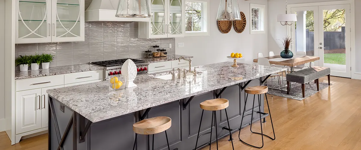 gray kitchen island with wooden chairs