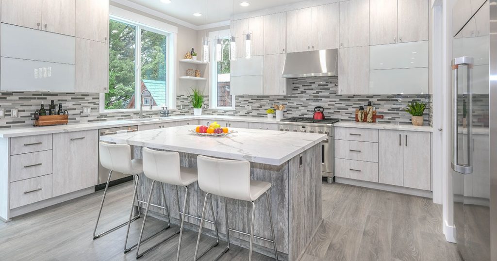 Standard counter height in a white kitchen with marble countertops