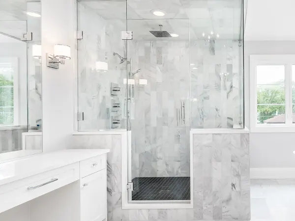 A glass-shower in a white bathroom