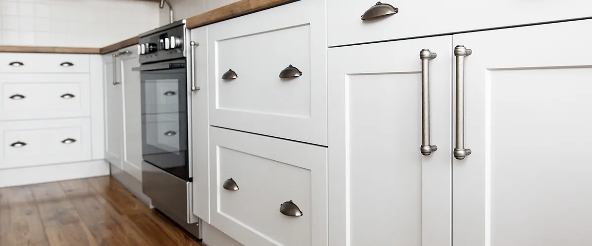 White kitchen cabinets with silver knobs and pulls