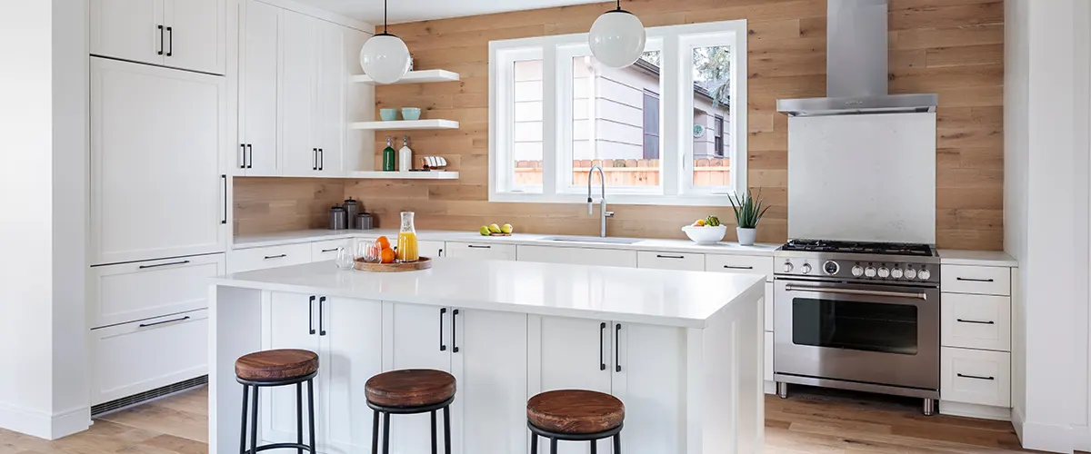 White kitchen with beige walls and dark hardware