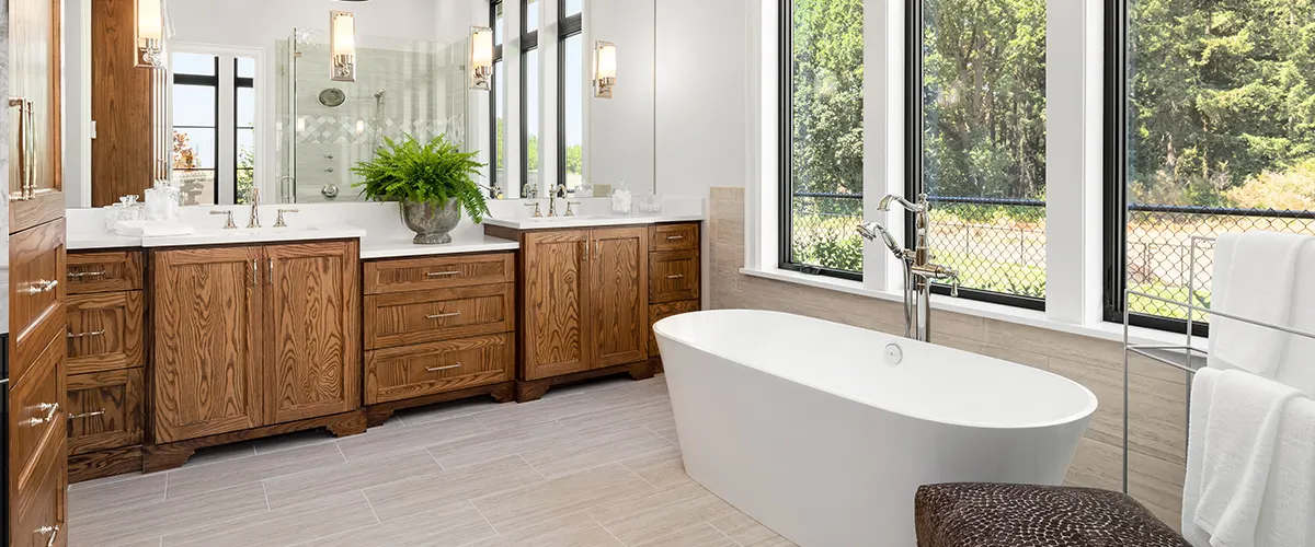 A bathroom with wooden cabinets and vanity with a tub