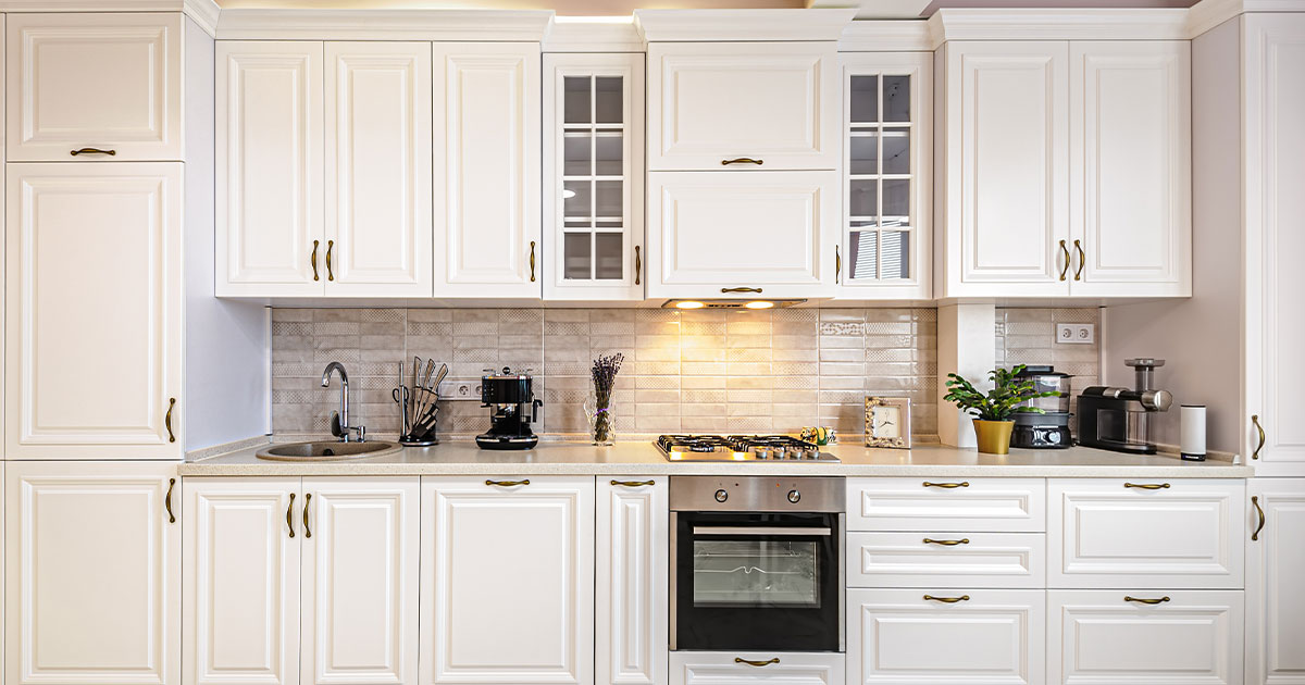 A kitchen with white transitional cabinets and a kitchen range