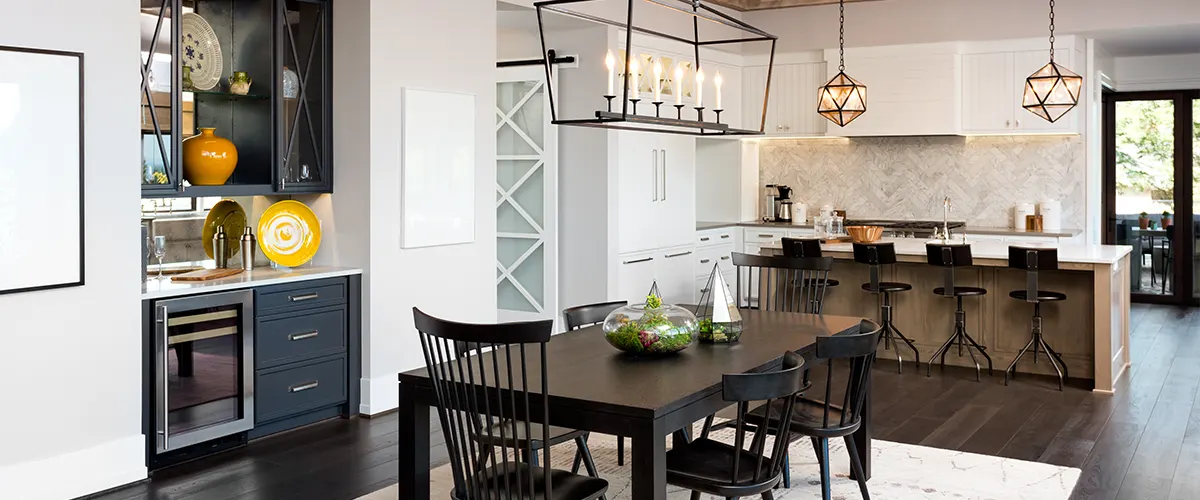 An open concept kitchen with a bar and a dining table