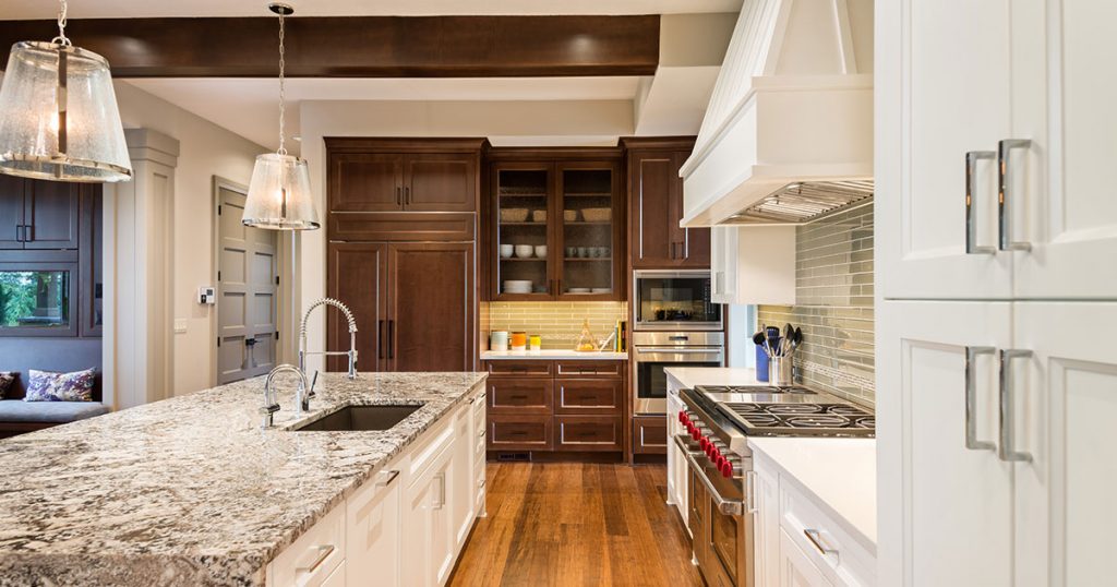 Kitchen cabinets accessories in a kitchen with wood flooring and white transitional cabinets