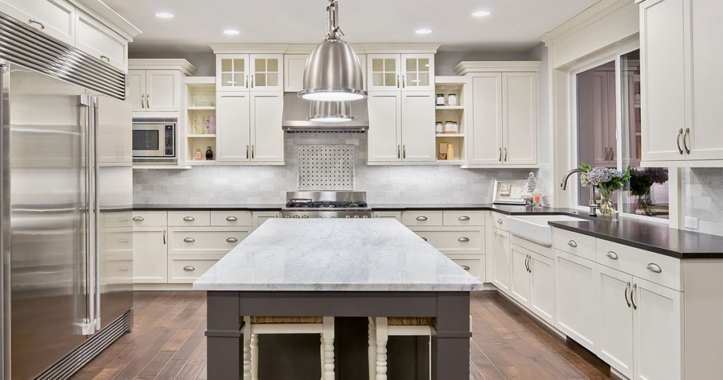 Best kitchen countertops materials in a kitchen with white transitional cabinets