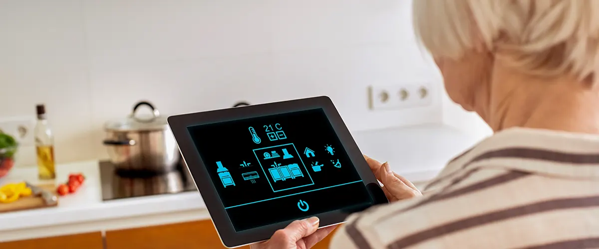 A woman using a tablet in her smart kitchen