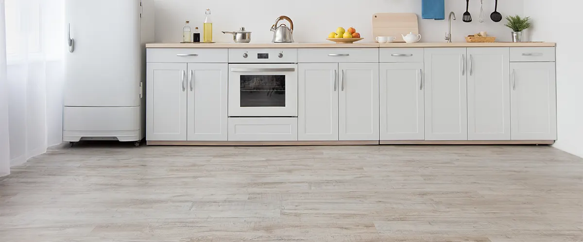 A white kitchen flooring with white cabinets and utensils