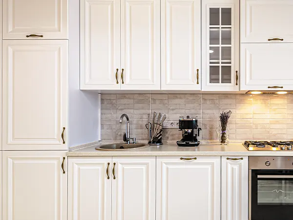 White cabinets with dark hardware and a glass cabinet door