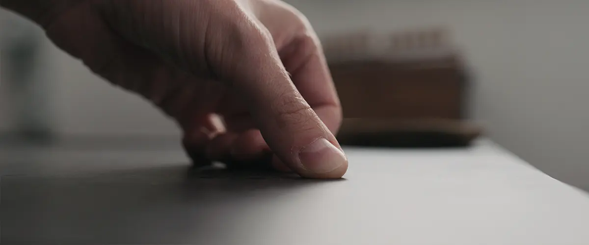 A man touching concrete countertops