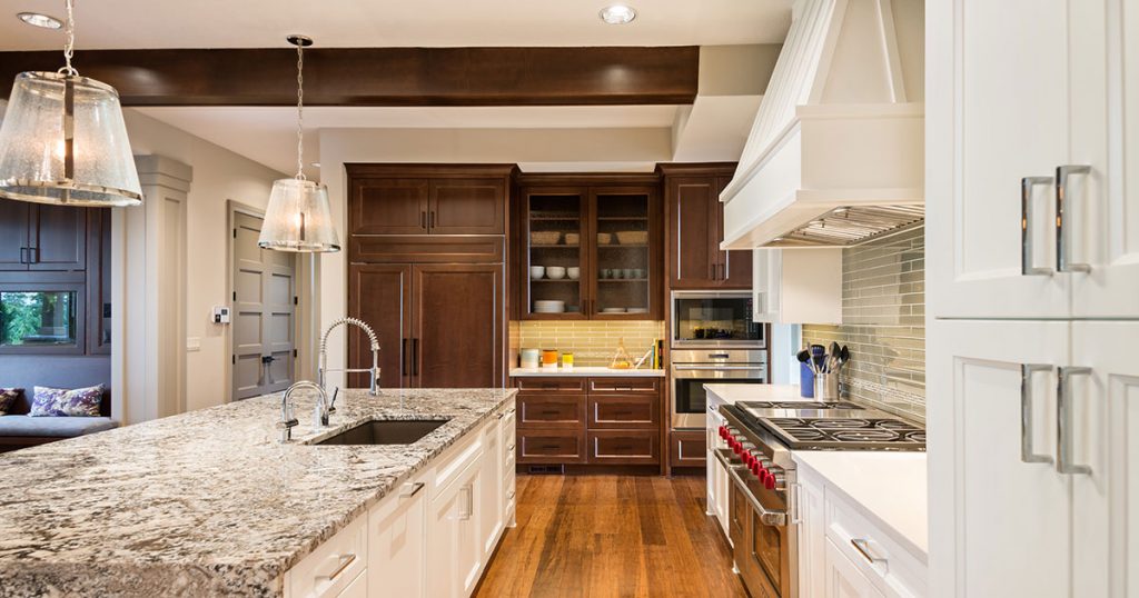 White kitchen cabinets with quartz countertops and dark wood cabinets combination