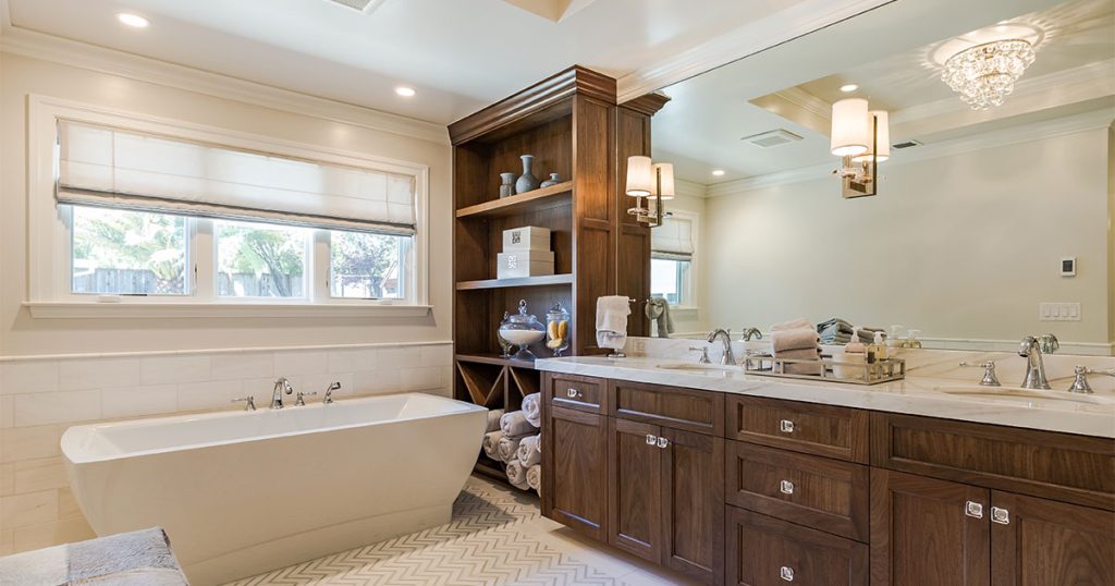 Wood double vanity with a freestanding tub and furniture with open shelves