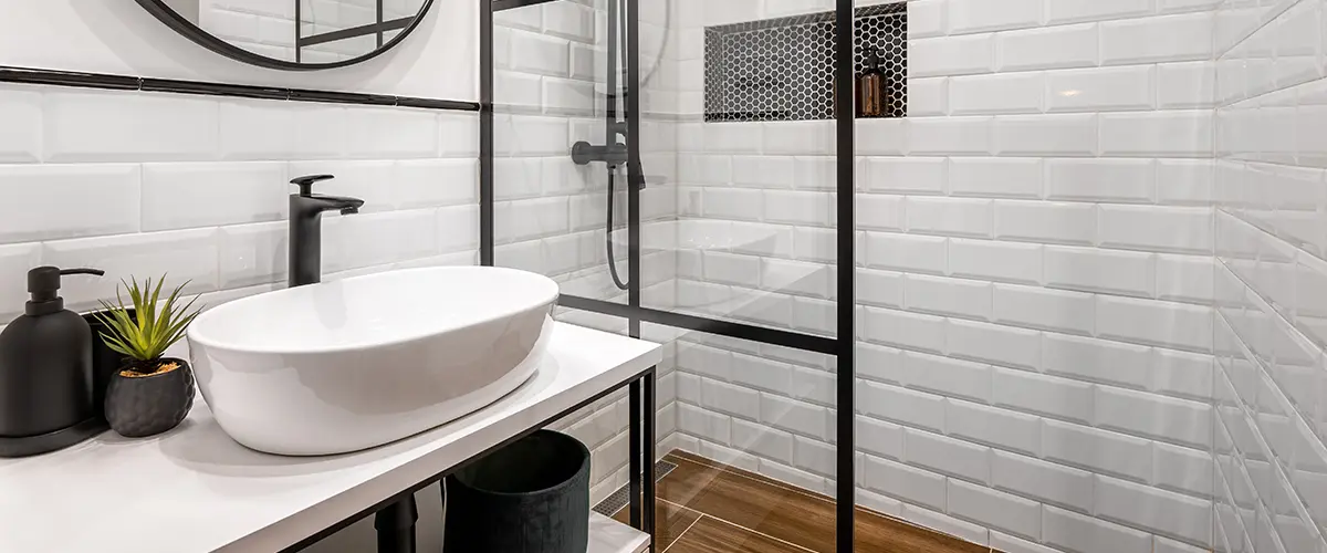 A contemporary bath style with black water fixtures and shower
