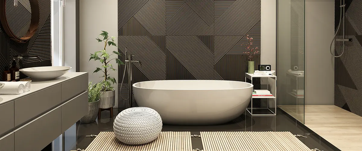 A beautiful bathroom renovation with black patterns on walls and a freestanding tub