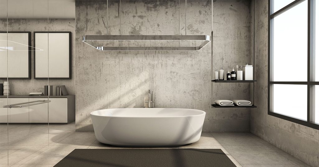 Freestanding tub in a gray bathroom with tile flooring