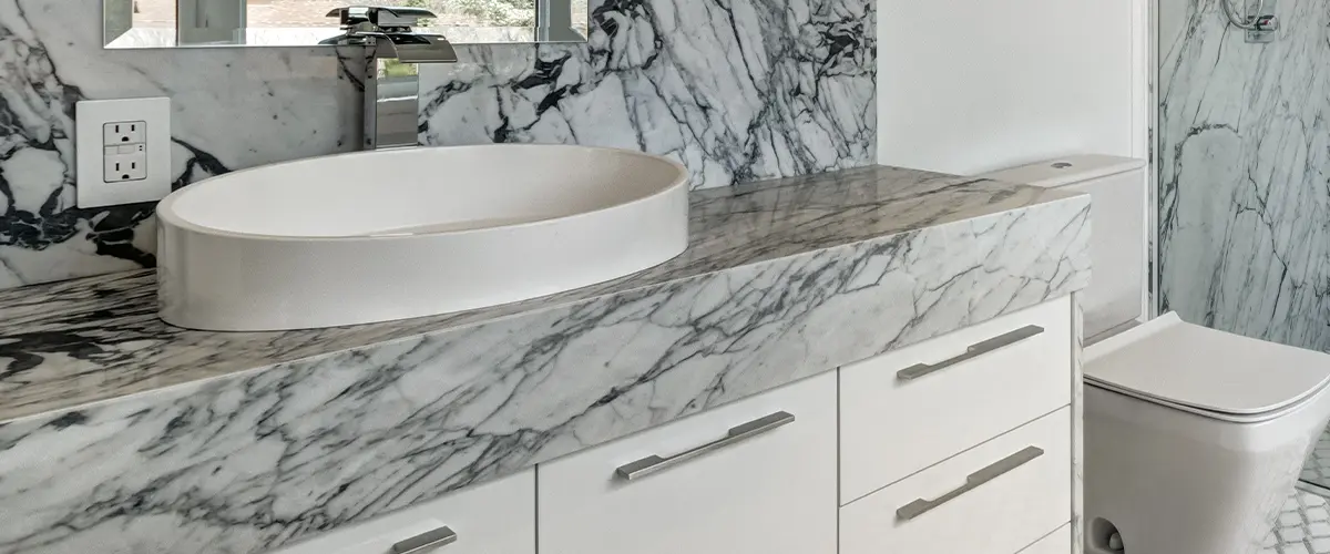 A quartz countertop with veins and vessel sink